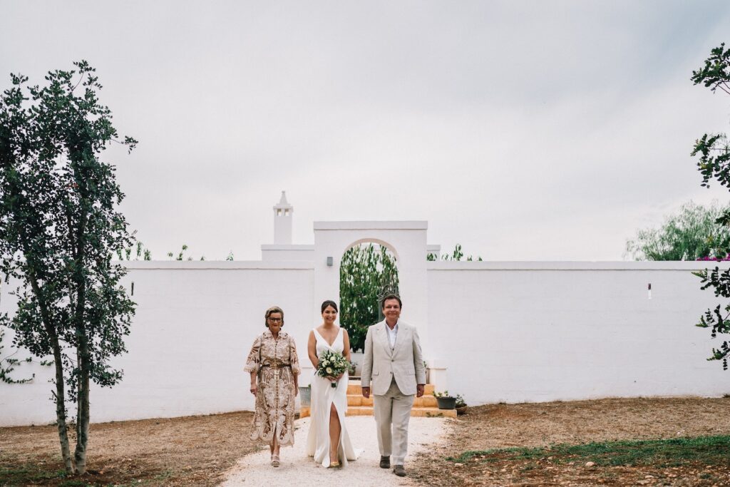 Destination Wedding at Masseria Le Torri in Pugliaceremonybride walking on the aile